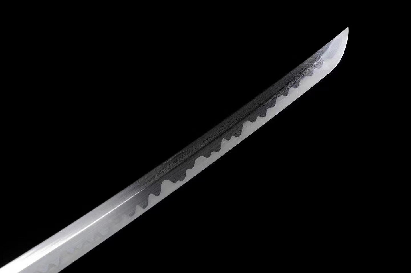 a large knife with a sharp blade on a black background