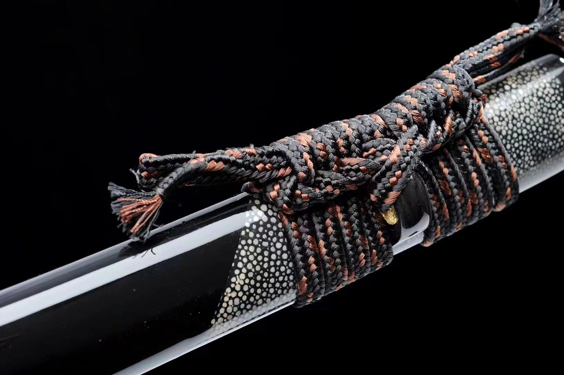 a close up of a knife with a rope on it